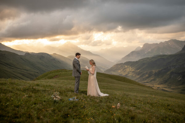 Elopement in the alps during sunset on a meadow mountain