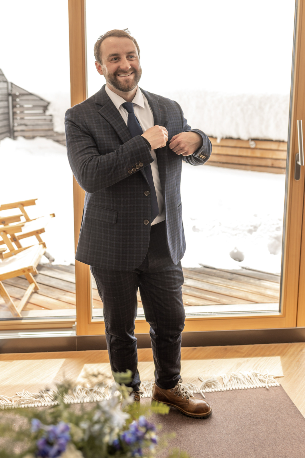 Groom getting ready for the wedding in the snow
