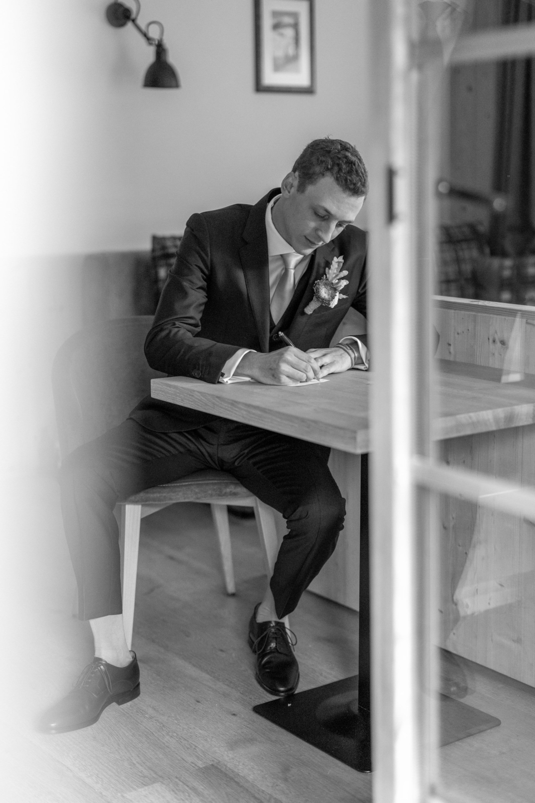 groom writes his vows for the wedding in the mountains in Austria