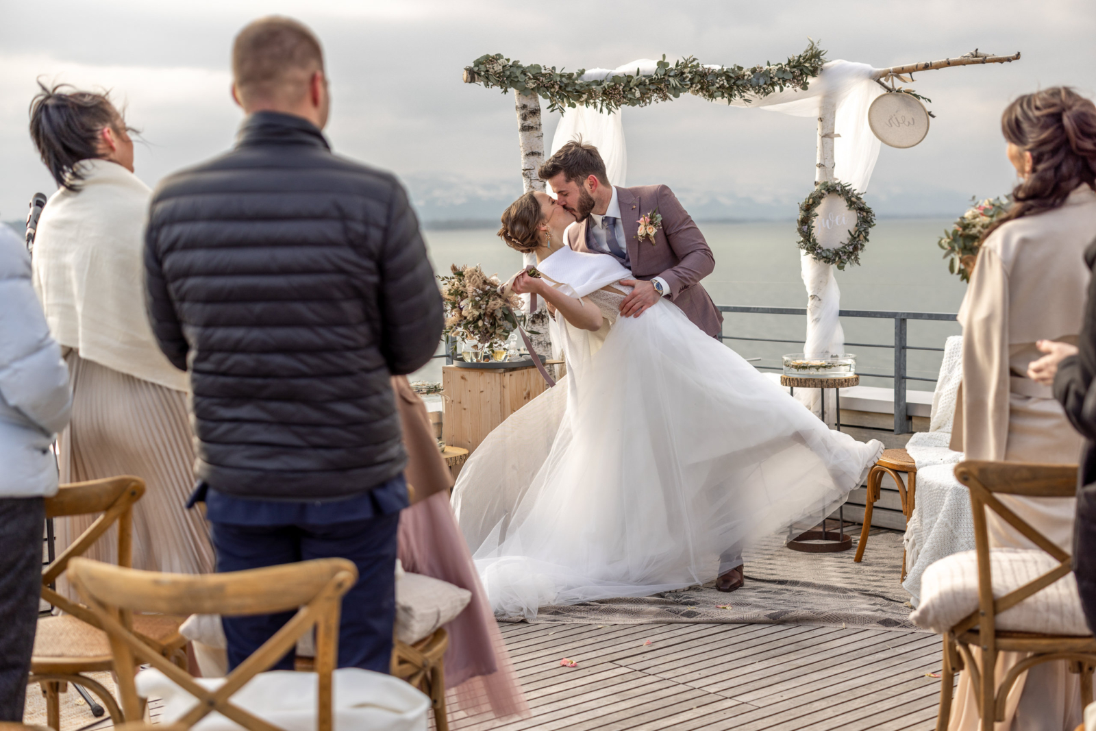 First Kiss during the winter wedding by the Lake of Constance