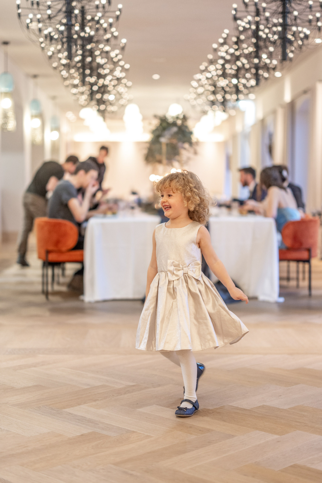 cute flower girl is dancing at the wedding reception